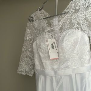 Wedding dress and veil with bow.